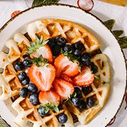 A brunch spread including fruit and waffles